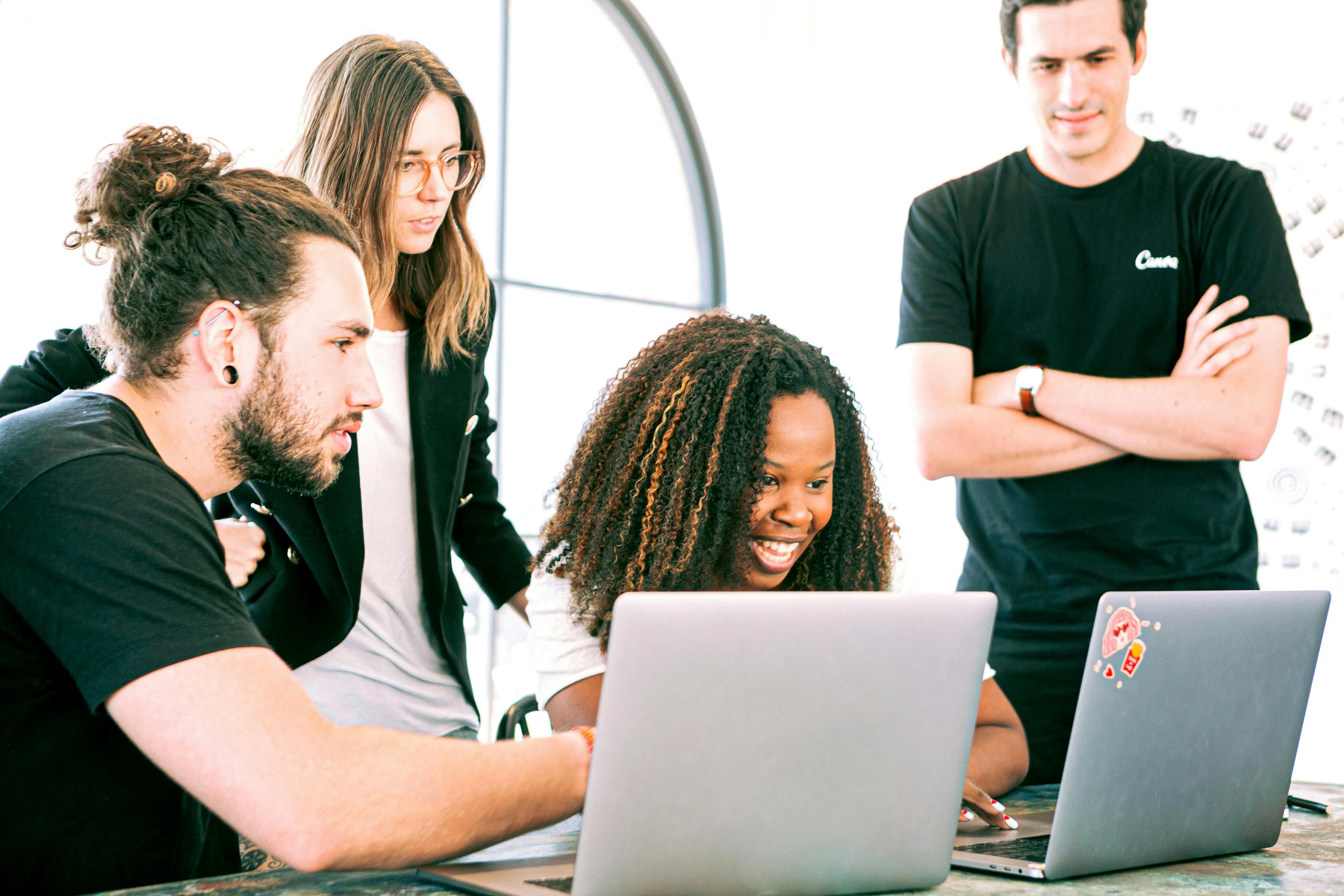 Developers collaborating over a laptop in an office